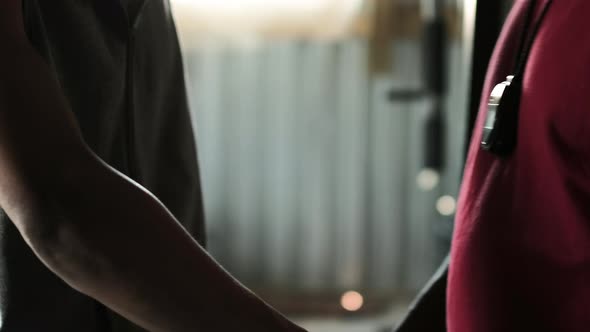 Coach wearing boxing gloves to a Boxer in the gym alt