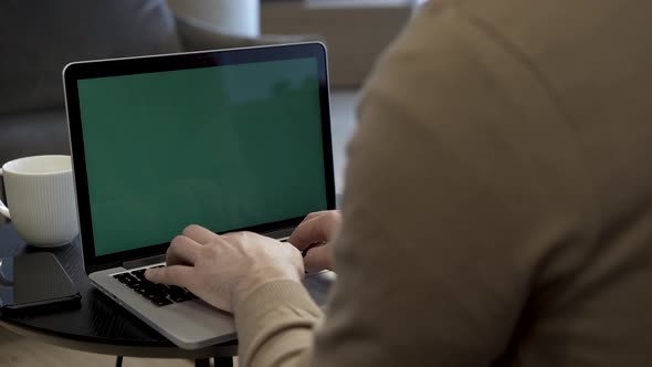 Male Person Working With Green Screen Laptop