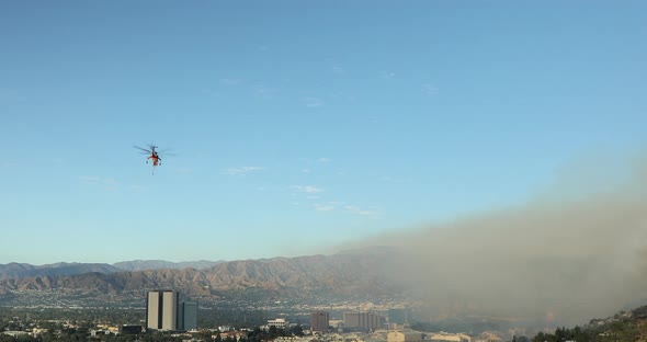 Close Drone Footage of Huge Wildfire in Hollywood Hills. Helicopter Extinguishing alt