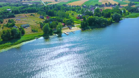 Epic Top Down Aerial View of Big Lake With Clear Blue Water. Reflection of Sky in Clear Lake in Even alt
