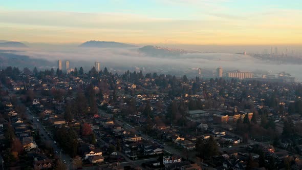 Stunning Sunset Fog over North Vancouver Neighborhood Homes and Rental Apartments in Canada - Drone alt