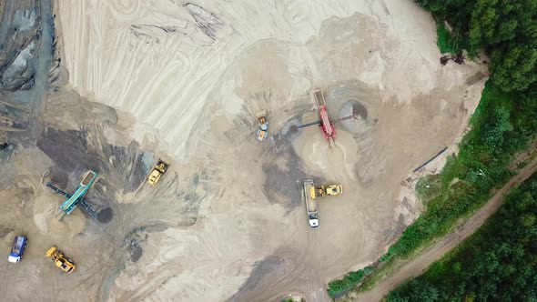 Excavator loader working at sand mine. Mining conveyor at industrial park. Mining machinery at sand alt