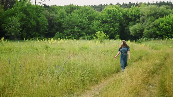Young Happy Woman Walks in Green Spring Fresh Nature Flowering Meadow Slow Motion alt
