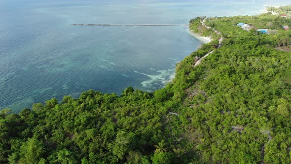 Aerial: Flying over tropical beach turquoise water coral reef , Indonesia alt