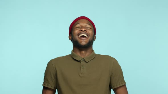 Slow Motion of Carefree African American Hipster Man in Beanie Having Fun Laughing and Smiling Happy