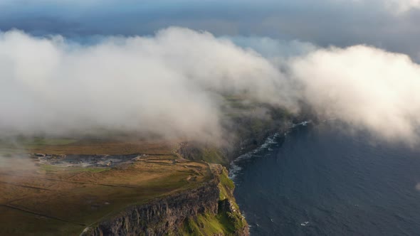 Aerial Panoramic Shot of High Cliffs Shrouded in Low Clouds alt