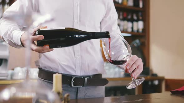 Sommelier Filling Glass with Wine in Restaurant Close Up Slow Motion alt