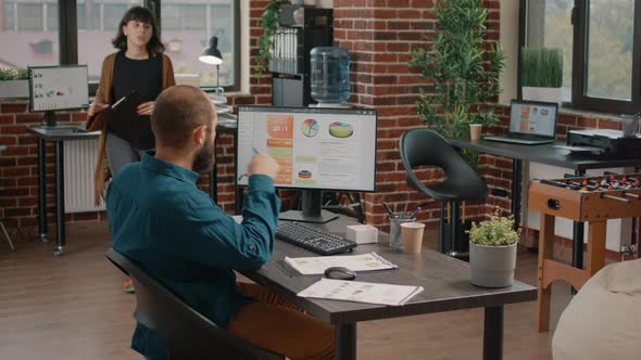 Business Man Asking for Help From Woman to Design Rate Charts alt