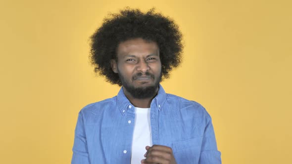 AfroAmerican Man Gesturing Failure and Problems on Yellow Background alt