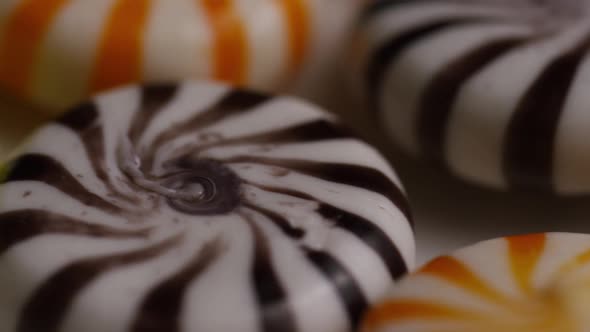 Rotating shot of a colorful mix of various hard candies  alt