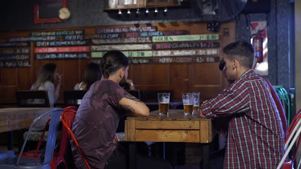 Guy joins with his friends to drink a beer at a local bar in Patagonia Argentina