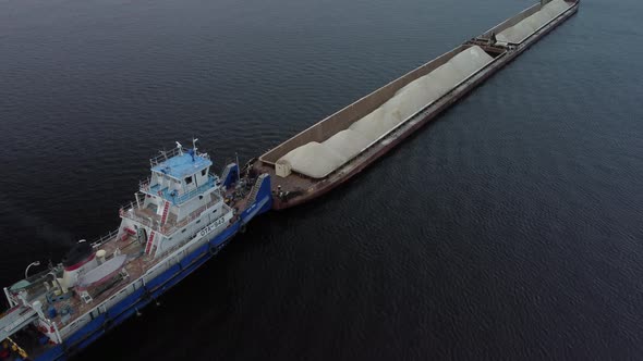 Aerial view of dry cargo ship docking on Volga river.