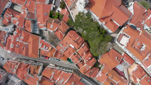 Aerial Overhead Top Down View of Orange Rooftops and Streets Between Small Colorful Houses in Dense alt