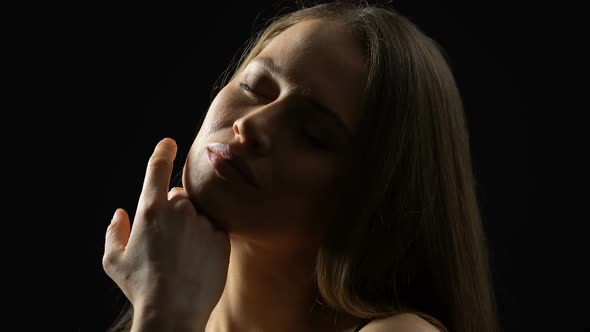 Attractive Female Touching Chin, Enjoying Perfect Skin After Plastic Surgery alt