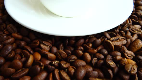 Cup with coffee on the background of coffee beans. alt