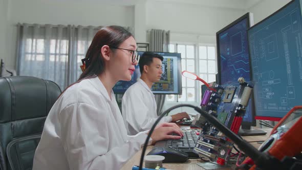 Development Facility: Asian Female Engineer Works On Computer With Cad Programming Software alt