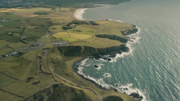 Ireland Rural Lands Aerial: Ocean Cliff Shoreline with Wide Green Grass Fields, Vales, Meadows alt