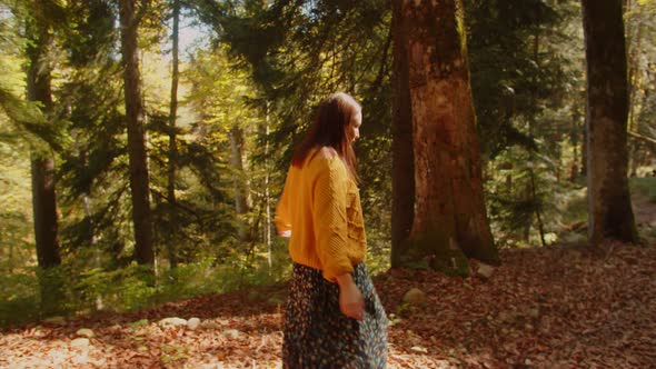 Nice Woman is Walking on the Scenic Autumn Forest