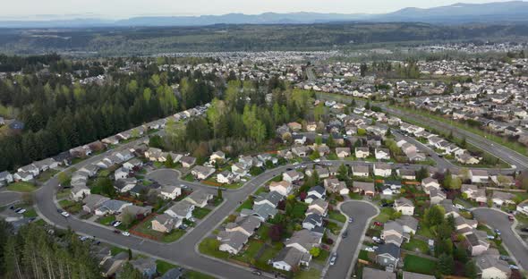 Wide aerial view of suburban neighborhoods as far as the eye can see. alt