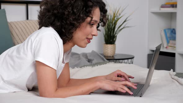 Smiling Hispanic Curly Woman Student Study Uses Laptop Distance Education alt