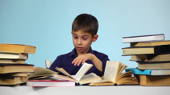 Tired Boy Takes Off and Puts on Glasses. Blue Background. Slow Motion alt