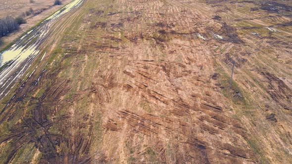 Scattered Heaps of Manure on a Farm Field in the Countryside alt