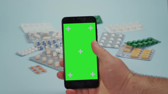 Man hand swipes on the smart phone green screen alt