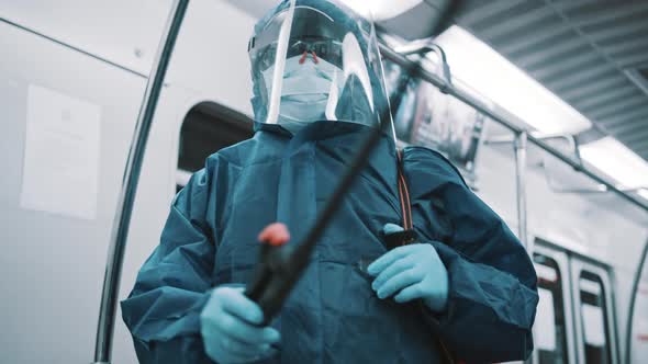 Cleaner with Protective Suit, Face Shield and Medical Mask Disinfecting Train alt