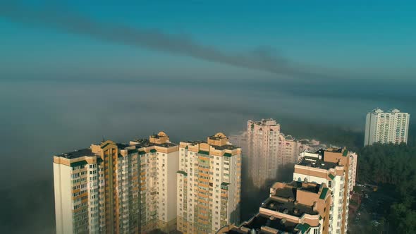 Aerial Drone Footage of Flying Over the City in Fog During Dawn
