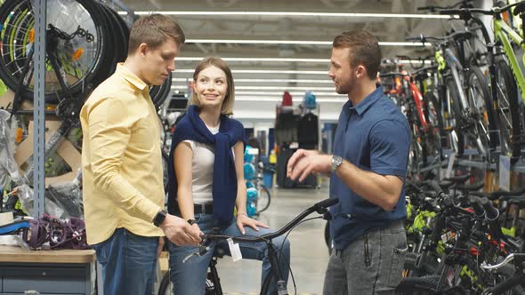 Handsome Confident Consultant Talk About Pros of Bicycle. alt