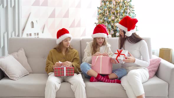 Young Mom with Kids Holding Christmas Presents