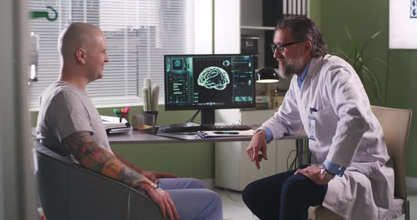 Happy Cancer Patient Thanking Doctor in Clinic alt