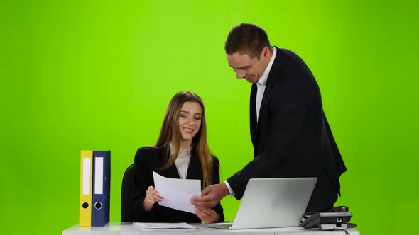 Office Workers Laughing at the Seen a Mistake in Document alt