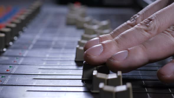 Faders Sliding Under Fingers of Record Producer alt