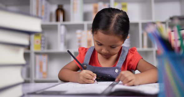 Portrait of Little girls do homework and sleep at the desk at classroom. alt