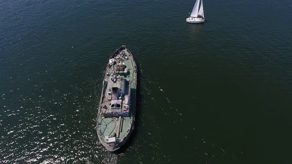 Aerial Shot of a Cargo Ship Floating in the Dnipro on a Sunny Day in Summer  