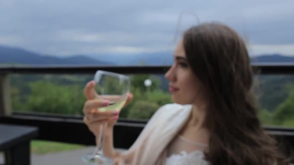 the Girl Drinks White Wine Sexy Young Woman with Glass of Wine alt