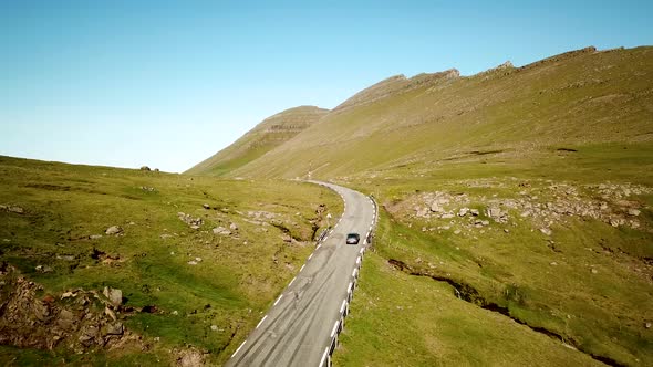 Aerial View of a Scenic Road with a Car Arriving to Slaettaratindur Mountain alt