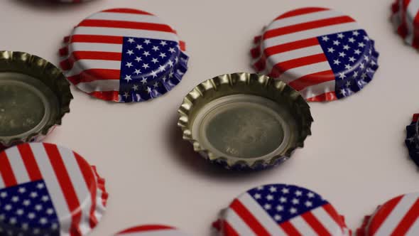 Rotating shot of bottle caps with the American flag printed on them  alt