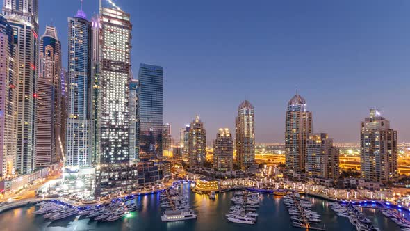 Dubai Marina Skyscrapers Aeral Day to Night Timelapse Port with Luxury Yachts and Marina Promenade alt