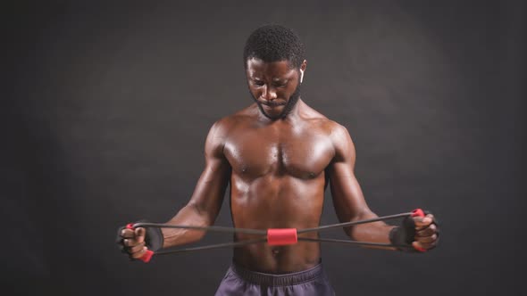 An Athletic AfricanAmerican in Good Athletic Shape is Engaged in Sports on an Isolated Dark alt