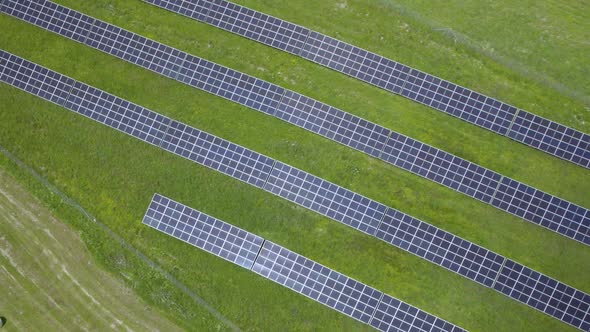 Aerial landing shot showing Solar Panel Farm Sun Energy Conservation Power Supply Sunset Green alt