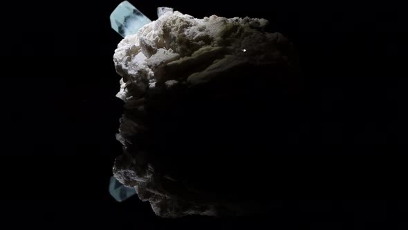 A single very clear crystal of aquamarine emerges from a feldspar matrix. Sample from Argentina. alt