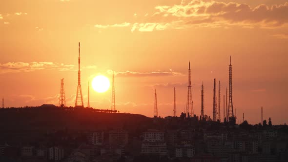 8K Sunset Behind High Antennas Towers