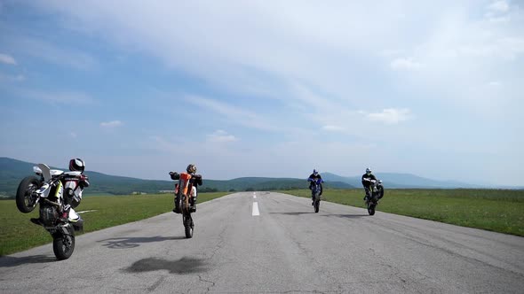 Slow motion motorcycles on the rear wheel alt