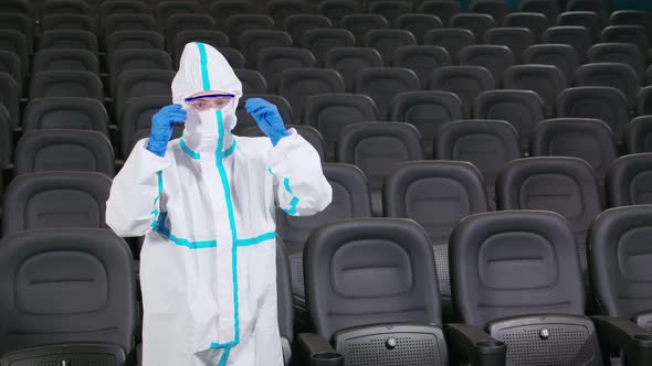 Disinfectant in Protective Suit Cleaning Cinema Hall alt
