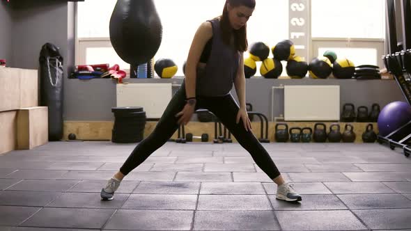 Young Beautiful Athletic Female Brunette Doiung Lunges Workout at the Gym alt