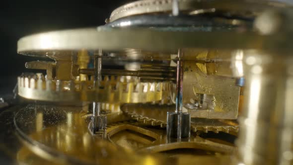 Inside View of a Moving Clockwork of Golden Mechanical Clock on Black Isolated Studio Background alt