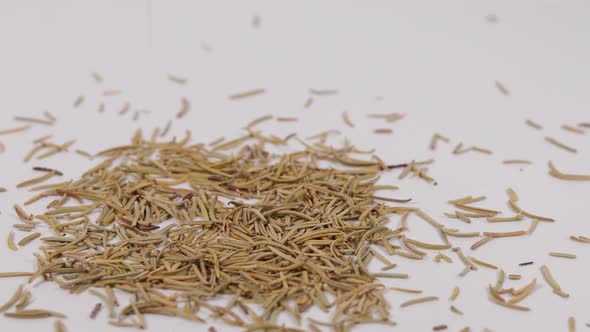 spices falling onto white table in heap. Scattered pieces of different shades.