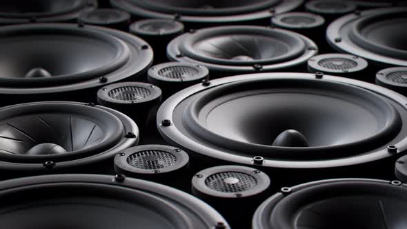 Vibrating speaker membranes stacked in endless loop. Lit by studio lights. 4K HD